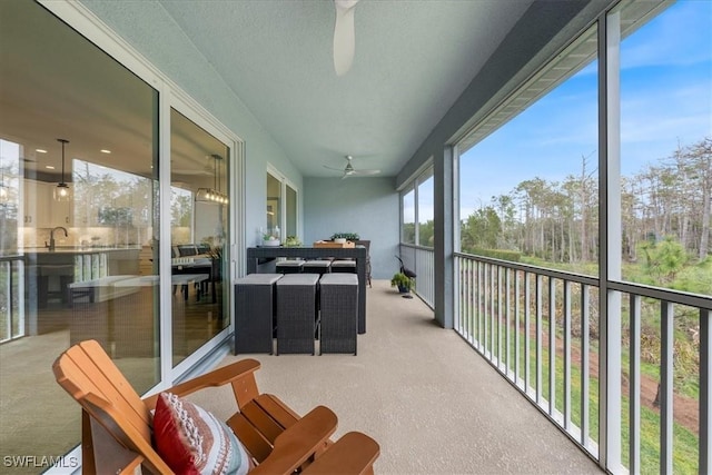 sunroom featuring a ceiling fan