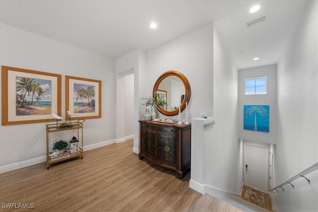 entryway with visible vents, baseboards, wood finished floors, and recessed lighting