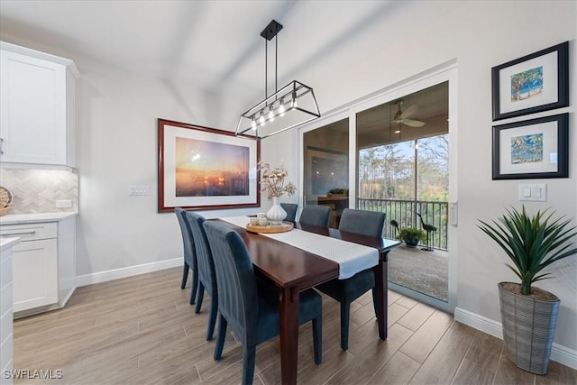 dining space with light wood finished floors and baseboards