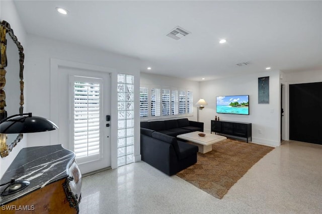 living room featuring speckled floor, visible vents, and recessed lighting