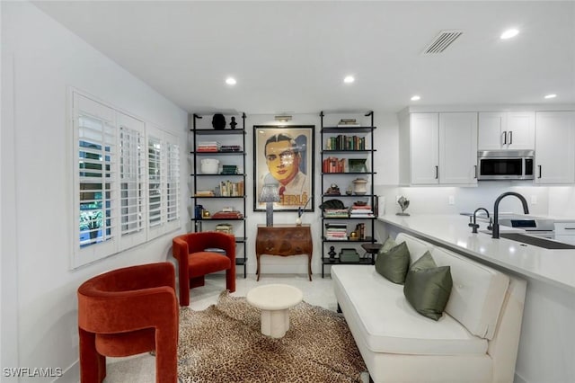 living area featuring visible vents and recessed lighting