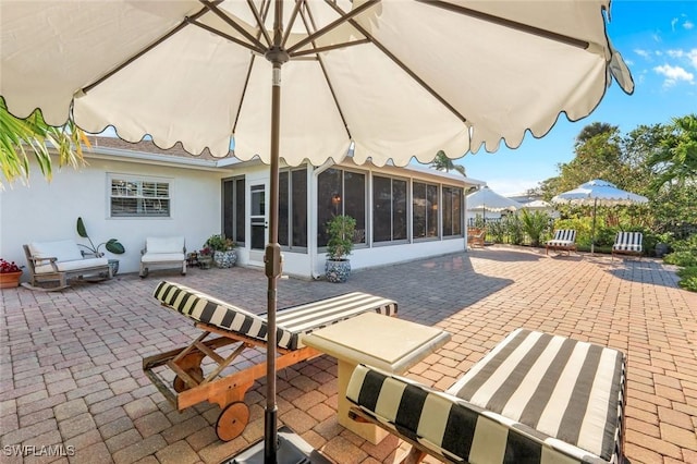 view of patio featuring a sunroom