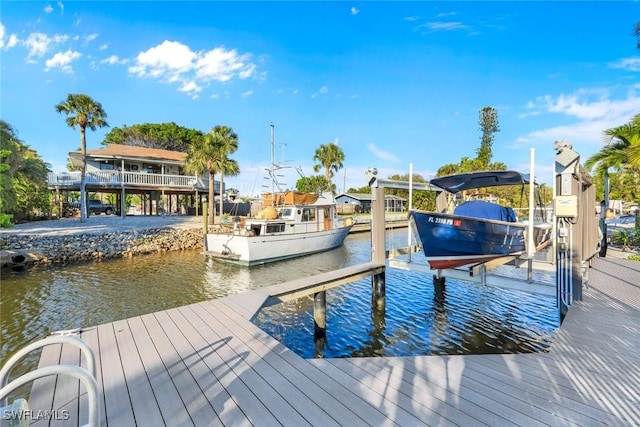 view of dock with boat lift and a water view
