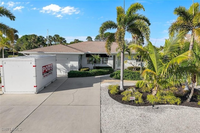 ranch-style house with an attached garage and driveway