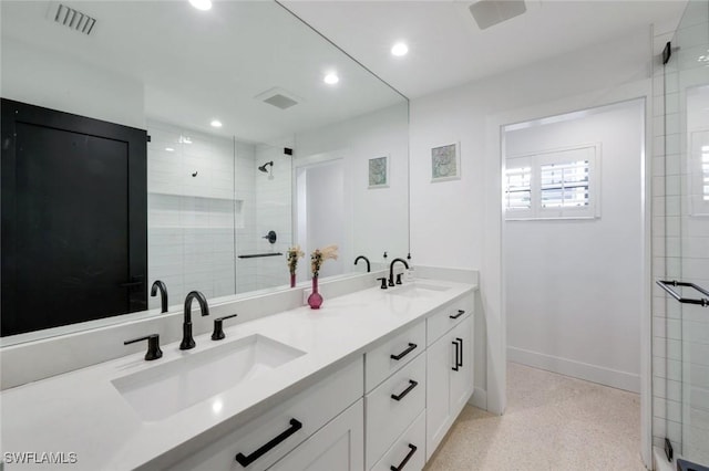 bathroom featuring baseboards, a sink, and a shower stall