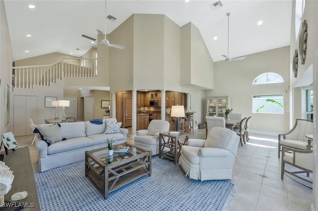 living room with visible vents, a ceiling fan, and light tile patterned flooring