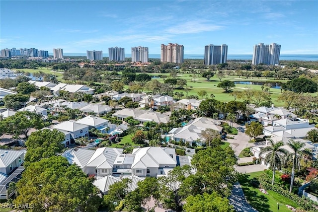 birds eye view of property with a water view and a city view