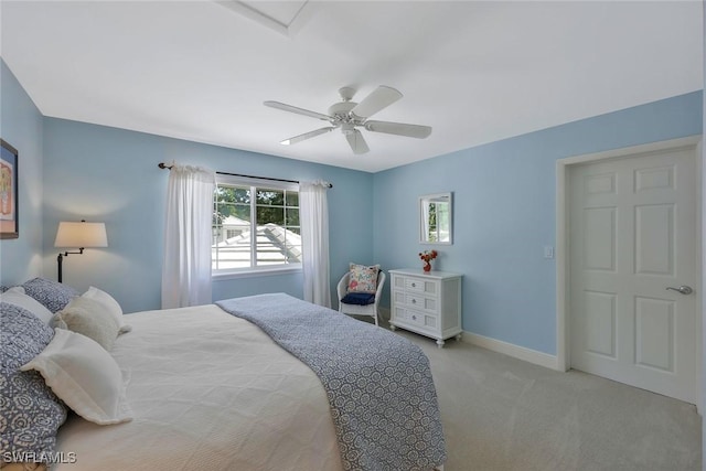 bedroom featuring baseboards, a ceiling fan, and light colored carpet