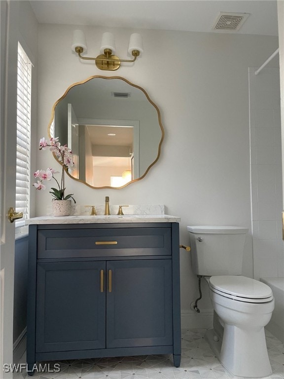 bathroom with visible vents, vanity, and toilet