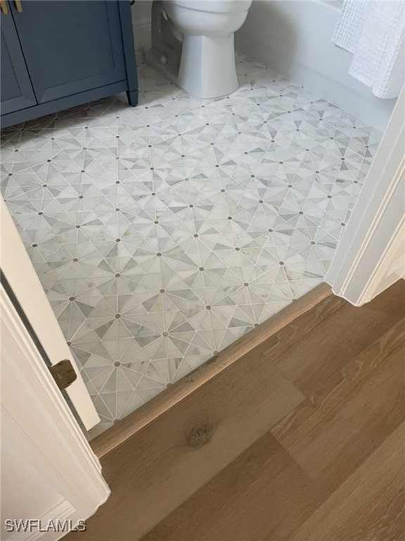 bathroom with toilet and tile patterned floors