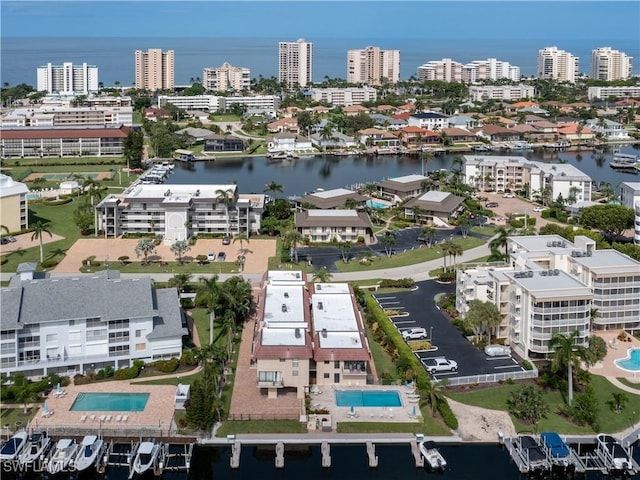 birds eye view of property featuring a water view and a city view