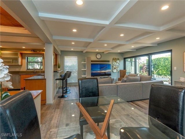 dining room with light wood finished floors, coffered ceiling, beam ceiling, and recessed lighting