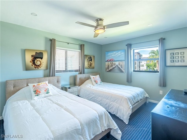 bedroom with a ceiling fan and baseboards