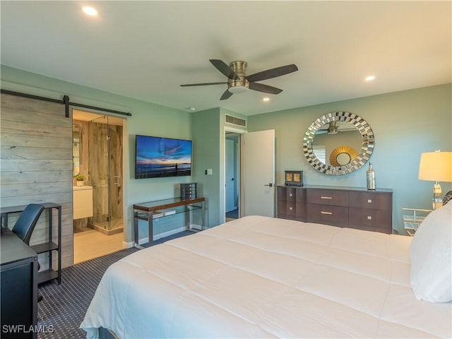 carpeted bedroom with a barn door, visible vents, and recessed lighting