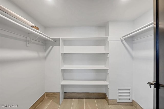 2501 Rio Grande Dr, Punta Gorda, FL 33950 - walk in closet featuring visible vents and wood tiled floor