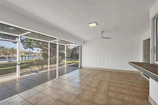 2501 Rio Grande Dr, Punta Gorda, FL 33950 - unfurnished room featuring tile patterned flooring, a ceiling fan, a water view, and a sunroom