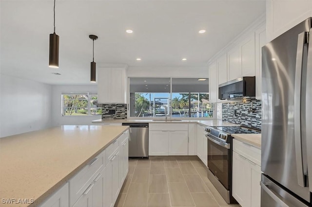 2501 Rio Grande Dr, Punta Gorda, FL 33950 - kitchen with a sink, stainless steel appliances, tasteful backsplash, and white cabinetry