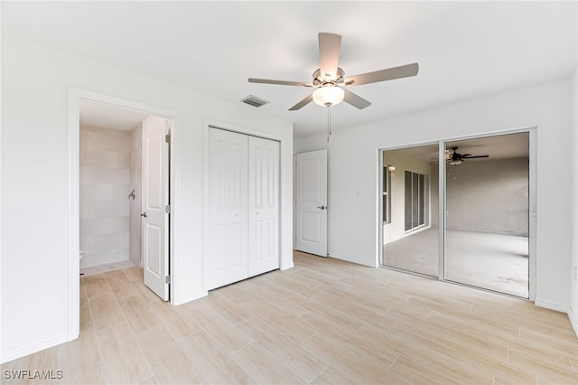 unfurnished bedroom featuring light wood-style floors, visible vents, baseboards, and ensuite bathroom