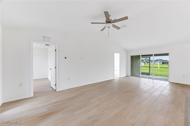 empty room featuring lofted ceiling, visible vents, light wood-style flooring, a ceiling fan, and baseboards