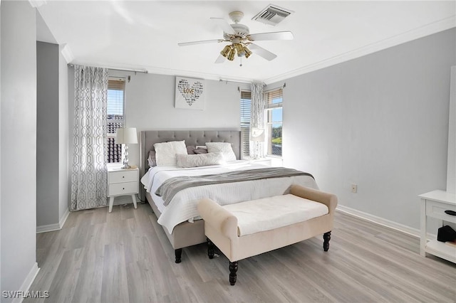 bedroom with visible vents, crown molding, and baseboards