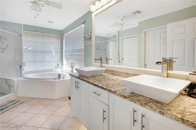 full bathroom featuring a ceiling fan, visible vents, a sink, and a shower stall