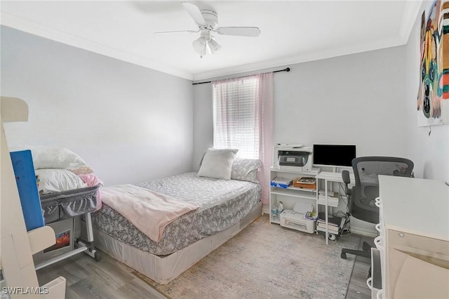 bedroom with ceiling fan, crown molding, and wood finished floors