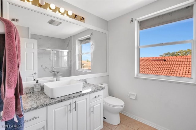 full bathroom featuring tile patterned flooring, toilet, vanity, baseboards, and a marble finish shower