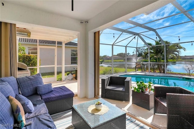 outdoor pool with a water view, a patio area, a lanai, and an outdoor hangout area