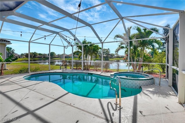 view of pool featuring a water view, a patio area, a pool with connected hot tub, and glass enclosure