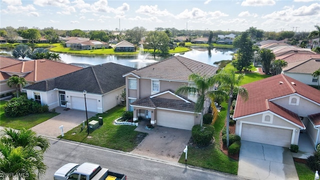 birds eye view of property featuring a water view and a residential view