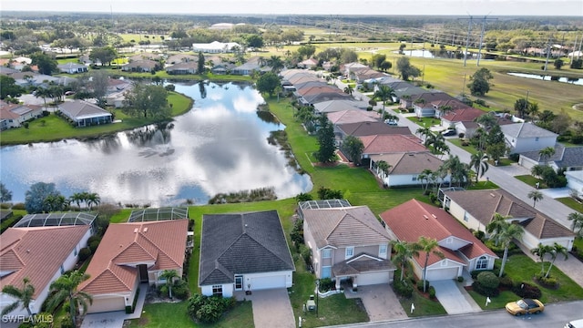 birds eye view of property with a water view and a residential view