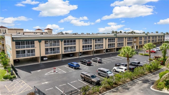 view of property featuring uncovered parking