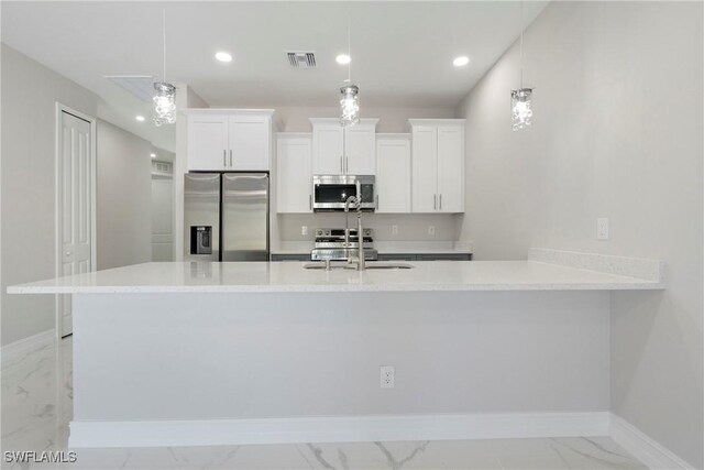 kitchen featuring visible vents, white cabinets, appliances with stainless steel finishes, marble finish floor, and a sink