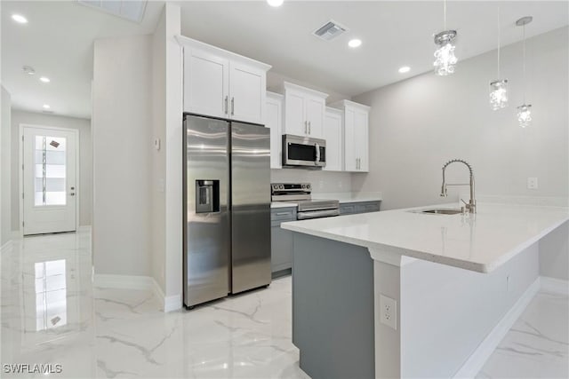 kitchen featuring stainless steel appliances, recessed lighting, marble finish floor, and a sink