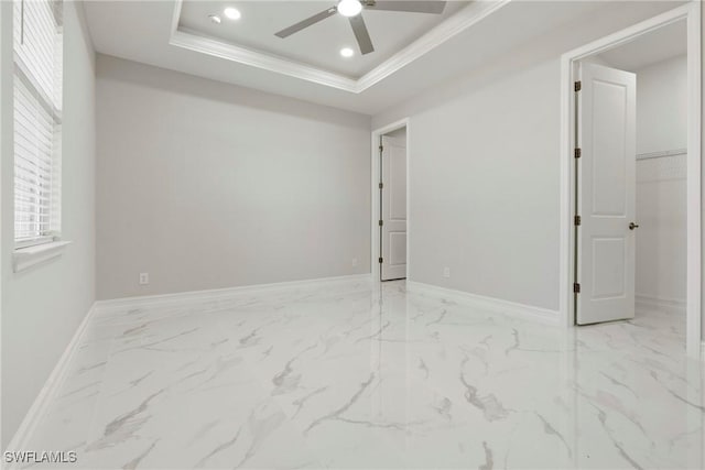 spare room featuring baseboards, ceiling fan, marble finish floor, a tray ceiling, and recessed lighting