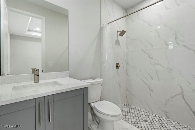 full bath featuring a stall shower, marble finish floor, vanity, and toilet