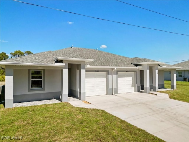 prairie-style home with roof with shingles, stucco siding, an attached garage, driveway, and a front lawn