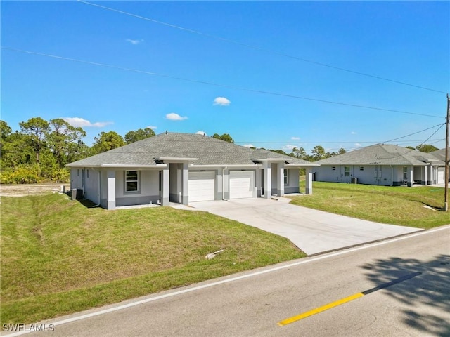 ranch-style home with a shingled roof, concrete driveway, an attached garage, a front lawn, and stucco siding