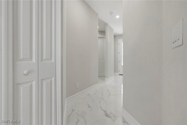 corridor featuring marble finish floor, visible vents, and baseboards