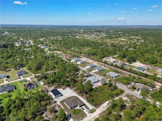 birds eye view of property with a forest view