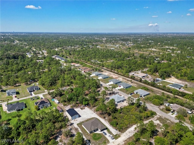 birds eye view of property featuring a view of trees