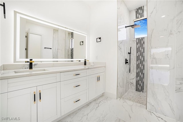 bathroom featuring marble finish floor, double vanity, a sink, and a marble finish shower