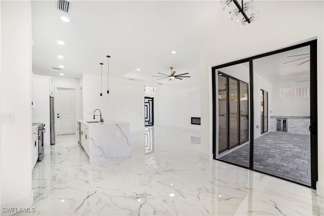 hallway featuring marble finish floor, a sink, visible vents, and recessed lighting