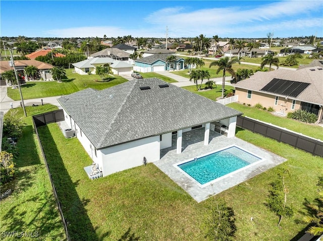 view of swimming pool with a fenced in pool, a patio, a fenced backyard, a residential view, and a yard