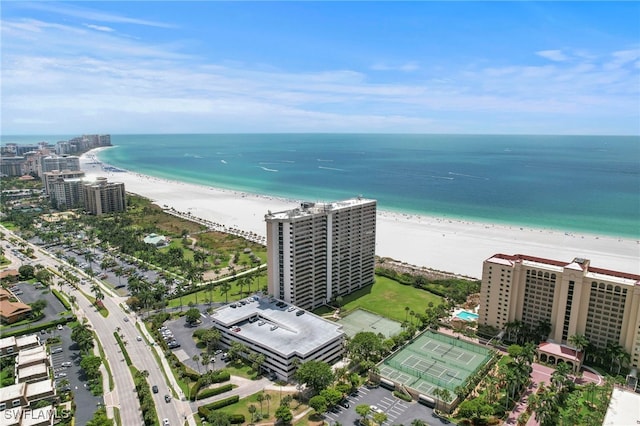 bird's eye view with a water view and a beach view