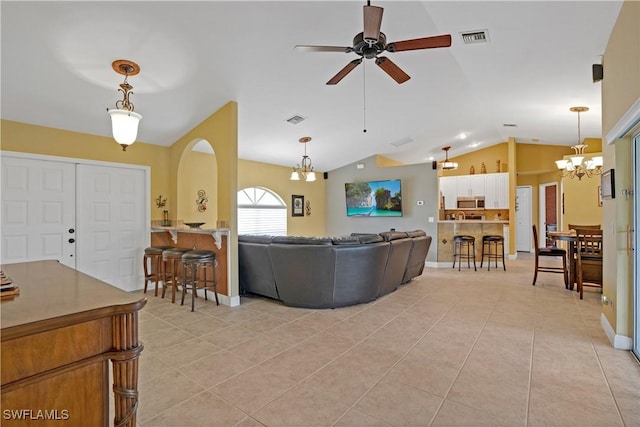 living room with lofted ceiling, ceiling fan with notable chandelier, light tile patterned flooring, and visible vents