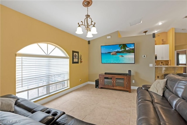 living area with lofted ceiling, light tile patterned floors, baseboards, and a chandelier