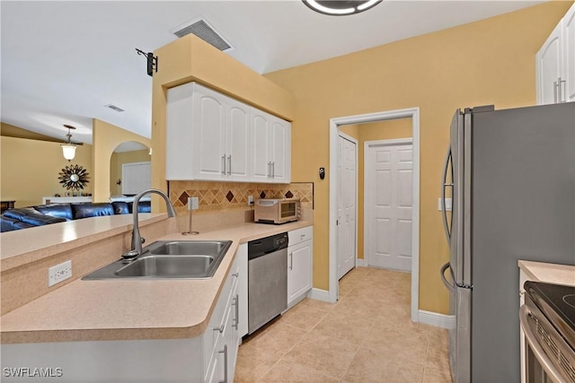 kitchen with stainless steel appliances, visible vents, a sink, and white cabinetry