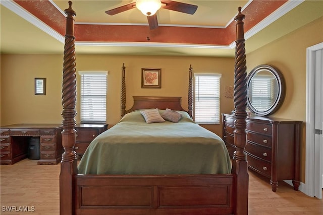 bedroom with light wood-style floors, ornamental molding, and a ceiling fan