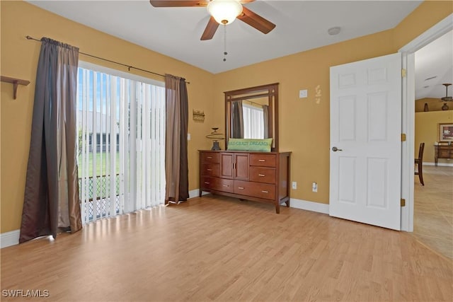 bedroom with baseboards, light wood finished floors, and access to exterior